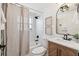Bathroom with shower-tub combo and wood vanity at 13617 Frances Ave, Hudson, FL 34667