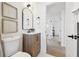 Bright bathroom featuring an elegant vanity, decorative wall art, and modern fixtures, creating a stylish and functional space at 13617 Frances Ave, Hudson, FL 34667