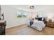 Bedroom with natural light, hardwood floors, bedside tables and a comfortable bed at 13617 Frances Ave, Hudson, FL 34667