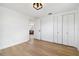 Spacious bedroom featuring a closet, modern light fixture, hardwood floors, and neutral walls at 13617 Frances Ave, Hudson, FL 34667