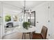 Bright breakfast nook with modern light fixture, round table, and views to the outdoors at 13617 Frances Ave, Hudson, FL 34667
