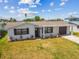 Charming single-story home featuring a well-manicured lawn, and an attached garage with a driveway at 13617 Frances Ave, Hudson, FL 34667