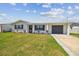 Charming single-story home featuring a well-maintained lawn, attached garage, and a welcoming front entrance at 13617 Frances Ave, Hudson, FL 34667