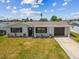 Charming single-story home featuring a well-manicured lawn, an attached garage, and a private driveway at 13617 Frances Ave, Hudson, FL 34667