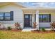 Modern front door with glass inserts and dark trim, set against a freshly painted exterior at 13617 Frances Ave, Hudson, FL 34667