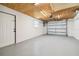 Large two car garage featuring ample parking and storage with white walls and a ply wood ceiling at 13617 Frances Ave, Hudson, FL 34667