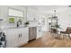 Bright kitchen features white cabinets, subway tile backsplash, stainless steel appliances, and hardwood floors at 13617 Frances Ave, Hudson, FL 34667