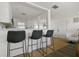 Bright open kitchen featuring modern black bar stools and a stylish breakfast bar at 13617 Frances Ave, Hudson, FL 34667