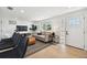 Bright living room with modern furniture, hardwood floors, and large windows for ample natural light at 13617 Frances Ave, Hudson, FL 34667