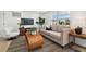 Bright living room featuring a comfortable sofa, stylish coffee table, and plenty of natural light from the window at 13617 Frances Ave, Hudson, FL 34667
