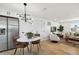 Spacious open living space with modern lighting, stainless appliances, and dining nook at 13617 Frances Ave, Hudson, FL 34667