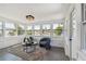 Sunroom with tile floors, many windows, and water views at 13617 Frances Ave, Hudson, FL 34667