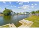 Waterfront view featuring a concrete bank and canal with blue skies and homes on the opposite bank at 13617 Frances Ave, Hudson, FL 34667