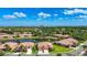 Scenic aerial view of a gorgeous community surrounded by mature trees and a tranquil lake at 146 Shell Falls Dr, Apollo Beach, FL 33572