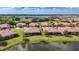 Aerial view of community showcasing red tile roofs, water features, and green spaces at 146 Shell Falls Dr, Apollo Beach, FL 33572