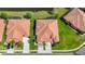 Aerial view of community highlighting roof lines, lush landscaping, and serene lake at 146 Shell Falls Dr, Apollo Beach, FL 33572