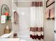 Bathroom featuring a vanity, toilet, and tub-shower with decorative accents and towel storage at 146 Shell Falls Dr, Apollo Beach, FL 33572
