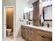 Bathroom featuring dual vanity with granite countertops, undermount sinks, and toilet area at 146 Shell Falls Dr, Apollo Beach, FL 33572