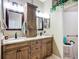 Bathroom featuring dual vanity with granite countertops, undermount sinks, and shower at 146 Shell Falls Dr, Apollo Beach, FL 33572
