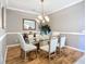 Dining room with a glass table, neutral walls, and decorative chandelier at 146 Shell Falls Dr, Apollo Beach, FL 33572