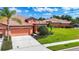 Inviting single-story home with a tile roof, lush lawn, and well-kept landscaping at 146 Shell Falls Dr, Apollo Beach, FL 33572