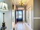 Bright foyer with neutral walls, chandelier, and view to the outside at 146 Shell Falls Dr, Apollo Beach, FL 33572