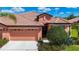 Charming single-story home featuring a tile roof, two-car garage, and well-maintained landscaping at 146 Shell Falls Dr, Apollo Beach, FL 33572