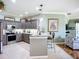 Stylish kitchen with stainless appliances, a breakfast bar, and an open view to the living room at 146 Shell Falls Dr, Apollo Beach, FL 33572