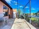 The covered lanai has a stone-look patio, two BBQ units and a view of the pond at 146 Shell Falls Dr, Apollo Beach, FL 33572