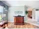 Cozy living room featuring a stylish bar, hardwood floors, and a seamless transition to other living spaces at 146 Shell Falls Dr, Apollo Beach, FL 33572