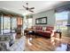 Bright living room with hardwood floors, comfortable seating, and a view of the patio and backyard at 146 Shell Falls Dr, Apollo Beach, FL 33572