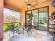 Charming outdoor patio with comfortable seating, ceiling fan and view to indoor living area at 146 Shell Falls Dr, Apollo Beach, FL 33572