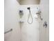 Bright shower area with white tile and grab bars for accessibility at 146 Shell Falls Dr, Apollo Beach, FL 33572