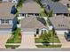 Aerial view of a charming home with solar panels, a lush lawn, and a well-maintained landscape at 15429 Caravan Ave, Odessa, FL 33556