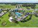 Stunning aerial of community resort-style pool surrounded by palm trees, and clubhouse at 15429 Caravan Ave, Odessa, FL 33556