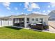 View of screened-in porch, well-kept lawn and hot tub at 15429 Caravan Ave, Odessa, FL 33556