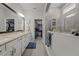 Elegant bathroom with dual vanities, a walk-in shower, and a spacious walk-in closet at 15429 Caravan Ave, Odessa, FL 33556
