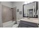 Well-lit bathroom with a shower-tub combo and a modern vanity with stylish fixtures at 15429 Caravan Ave, Odessa, FL 33556