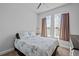 Cozy bedroom with a large bed, neutral tones, and lots of natural light at 15429 Caravan Ave, Odessa, FL 33556