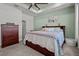 Relaxing bedroom showcasing a large bed, tray ceiling, a ceiling fan, soft colors and carpeted floors at 15429 Caravan Ave, Odessa, FL 33556