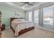 Serene bedroom featuring a tray ceiling, soft carpet, and plenty of natural light at 15429 Caravan Ave, Odessa, FL 33556