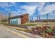 Attractive community entrance sign with colorful flowers at 15429 Caravan Ave, Odessa, FL 33556
