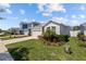 Charming one-story home with a well-manicured lawn and inviting curb appeal under a sunny blue sky at 15429 Caravan Ave, Odessa, FL 33556