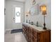 Inviting foyer with decorative console table, lamps, and a view of the front door at 15429 Caravan Ave, Odessa, FL 33556
