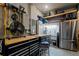 Well-organized garage with tool chests, work bench, shelving, a mini fridge, and a pegboard at 15429 Caravan Ave, Odessa, FL 33556