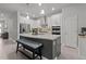 Modern kitchen featuring an island with seating and stainless steel appliances at 15429 Caravan Ave, Odessa, FL 33556