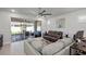 Comfortable living room with a ceiling fan, tile flooring, and access to the outdoor patio at 15429 Caravan Ave, Odessa, FL 33556