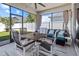 Enclosed porch featuring an outdoor dining table and cushioned seating, perfect for entertaining at 15429 Caravan Ave, Odessa, FL 33556