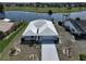 Beautiful aerial view of the home with a lake view and well-manicured landscaping at 1806 Wolf Laurel Dr, Sun City Center, FL 33573