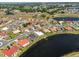 Stunning aerial view of a lakeside home in a vibrant community with lush landscaping and access to a tranquil lake at 1806 Wolf Laurel Dr, Sun City Center, FL 33573